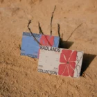 A couple of business card mock-ups on a sandy surface
