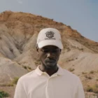 African-american man wearing a hat mock-up in a desert environment