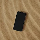 Iphone mock-up on a sandy surface