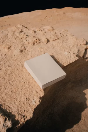 Block of magazine mock-ups on top of a rocky surface