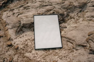 Framed poster mock-up on a rocky surface