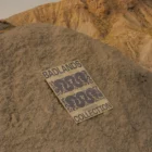 Poster mock-up on top of a little sandy mountain in a desert environment