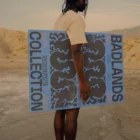 Black person holding a poster mock-up in a desert environment