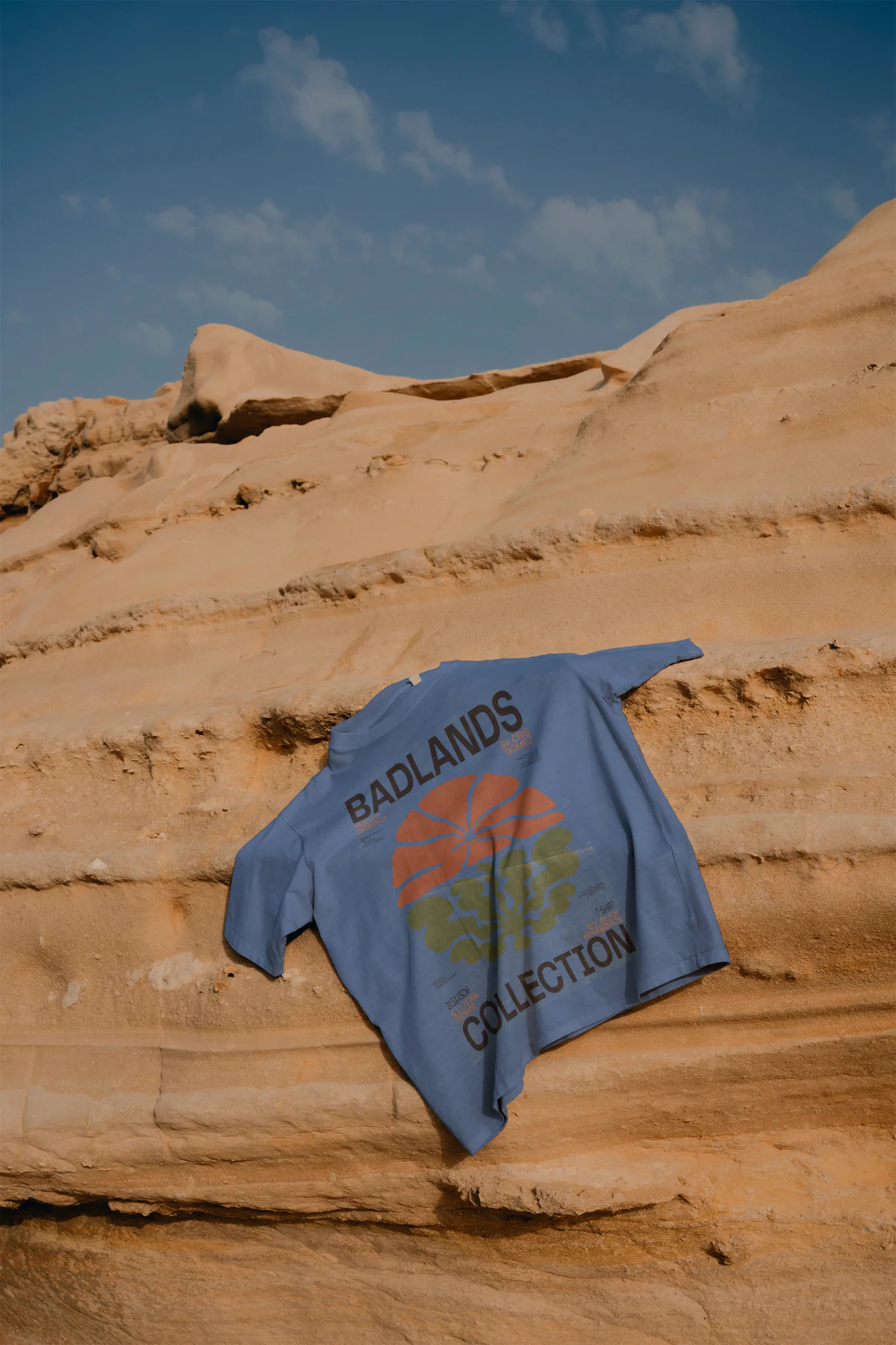 T-Shirt mock-up on a rocky mountain with a blue sky behind