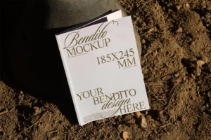 Book mockup over soil with natural light.