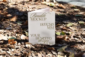 Book mockup placed in the center of fallen autumn leaves.