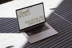 Macbook mockup on neutral background with lights and shadows.