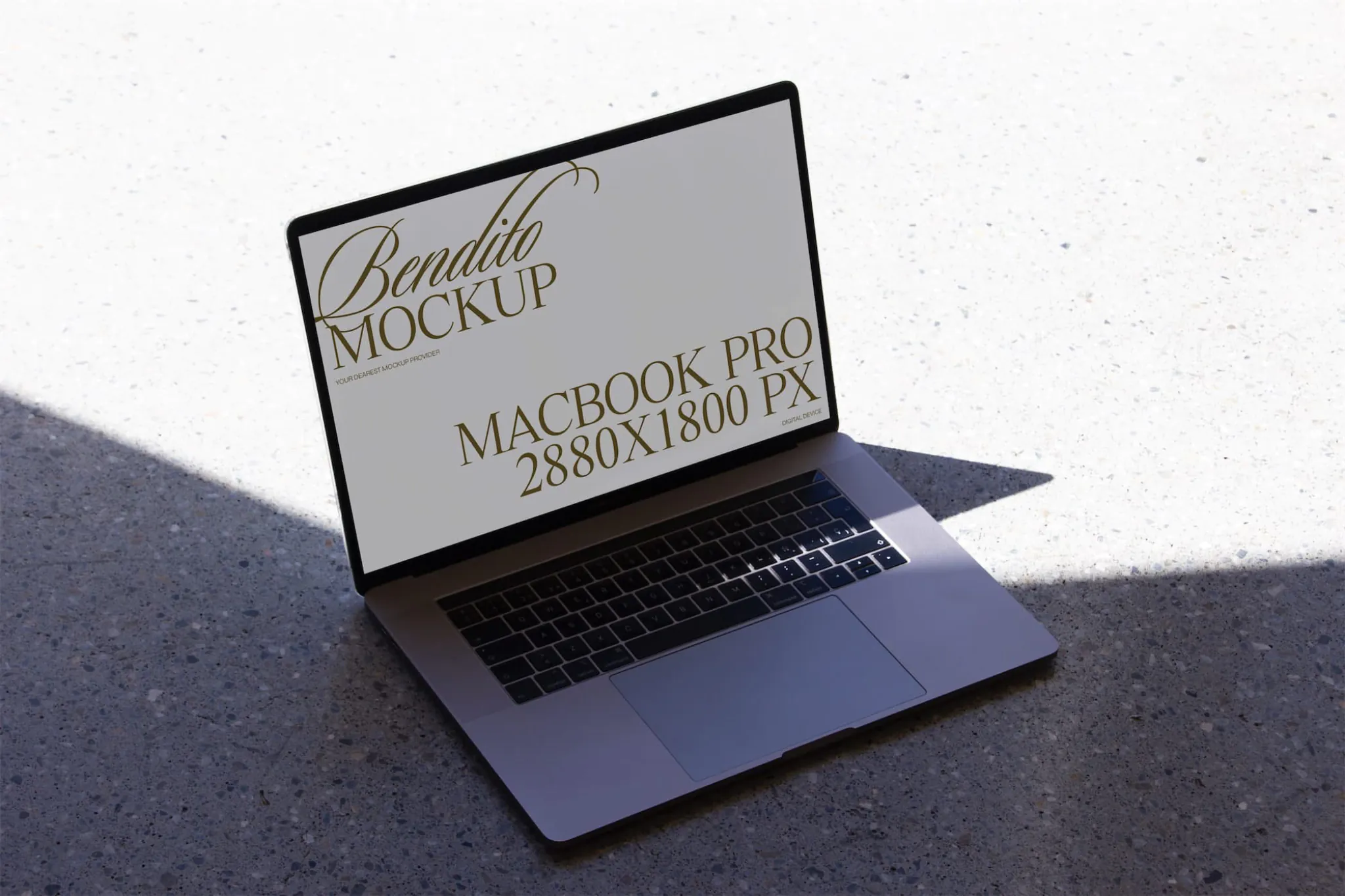 Macbook mockup on neutral background with natural light and shadows.