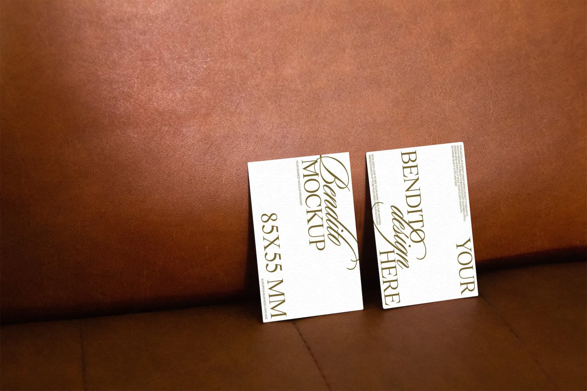 Vertical business card mockup on leather background.
