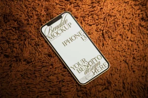 Iphone mockup on luxurious orange fabric.