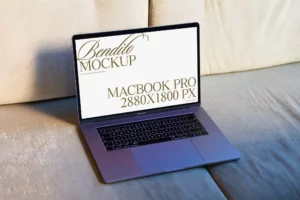 Macbook mockup on beige velvet fabric.