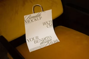 White paper bag mockup on yellow velvet chair.