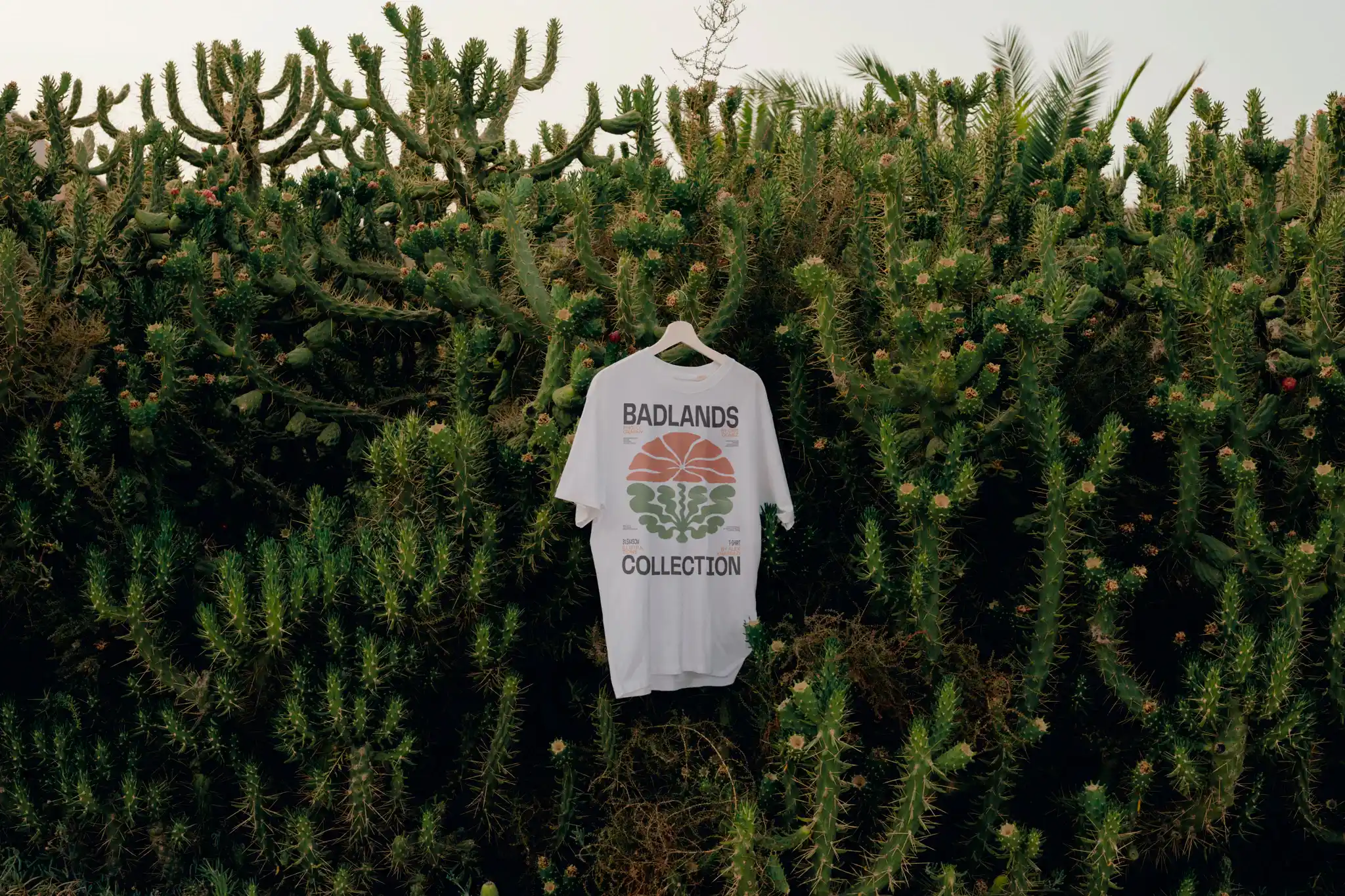 T-shirt mockup freebie in the middle of a bunch of cactus and vegetation.
