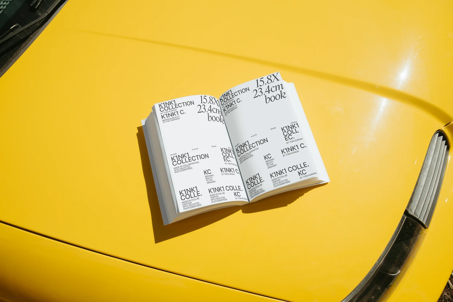 Open book mockup on a yellow car surface.