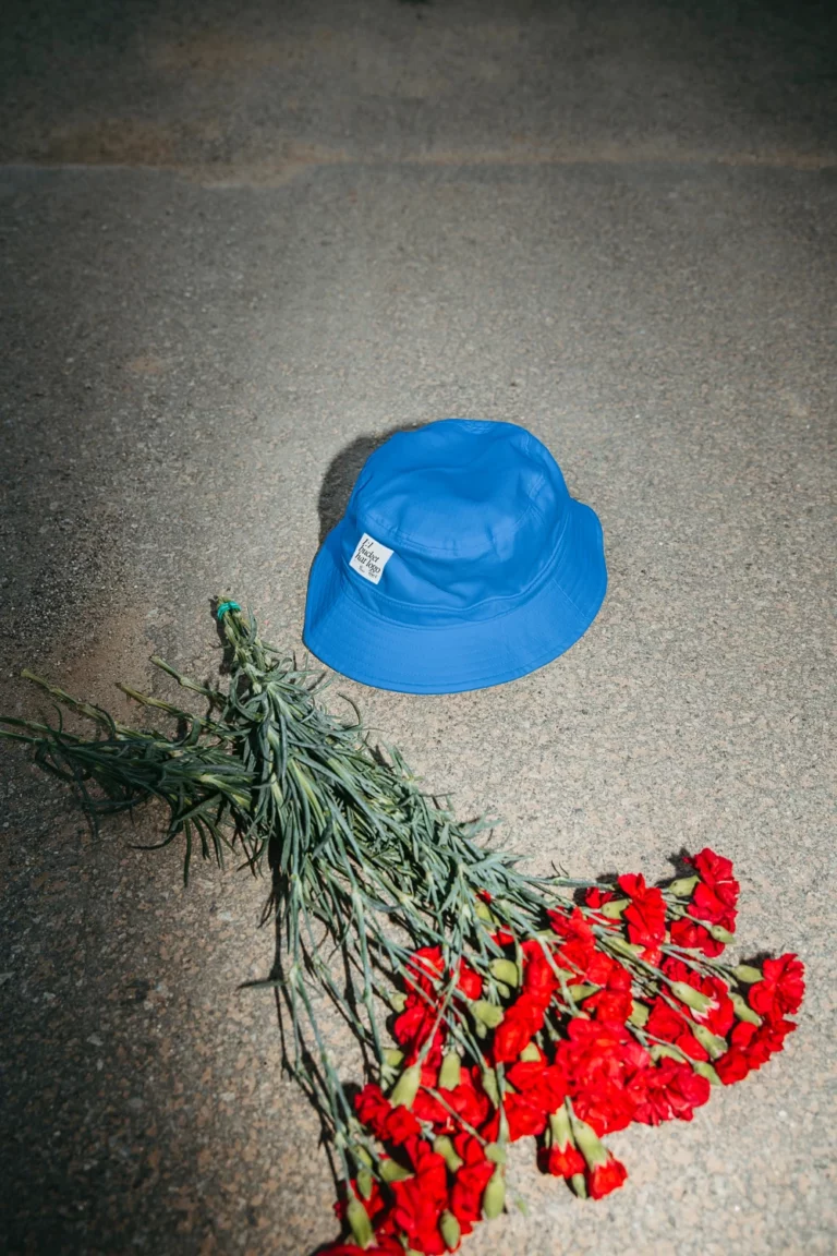 Bucket hat mockup in the street next to a bouquet of flowers.