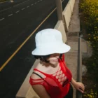 Bucket hat mockup worn by a female model in the highway.