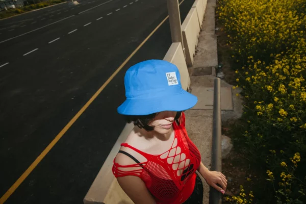 Bucket hat mockup worn by a female model in the highway.