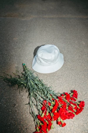 Bucket hat mockup in the street next to a bouquet of flowers.