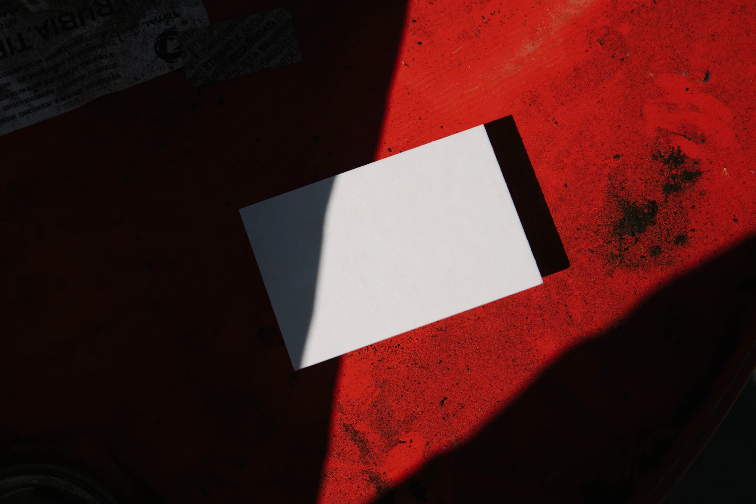 Creative business card mockup on a rusty barrel with a big contrast between light and shadows.