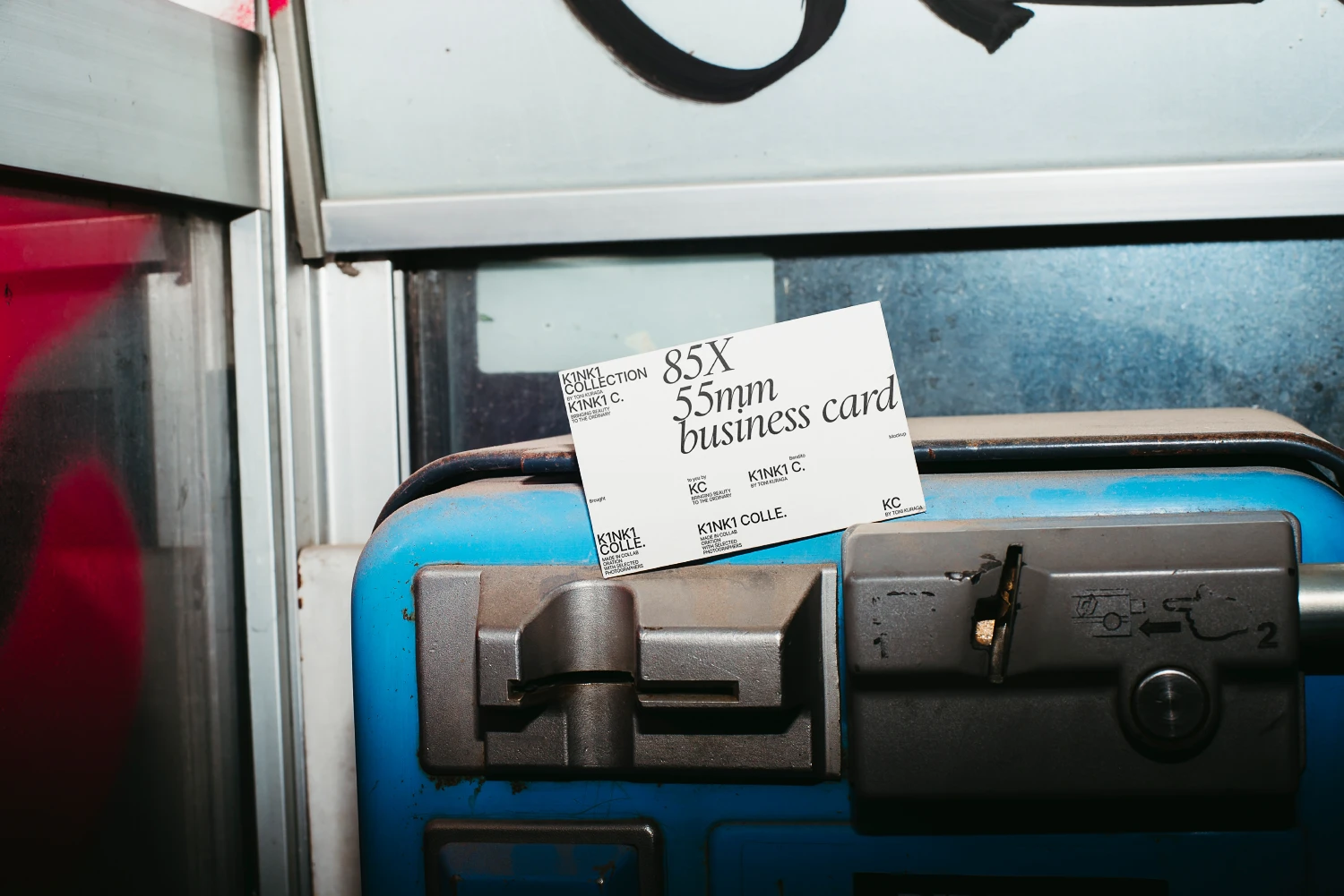Business card mockup in the inside of a telephone booth.