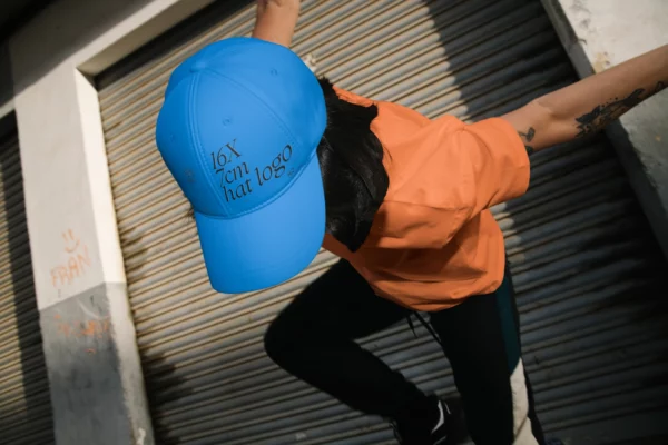 Creative baseball cap mockup worn by a female model in a urban background.