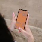 iPhone mockup in the hands of a girl with painted nails.
