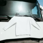 Jumper mockup hanging by a wiper blade of a truck.