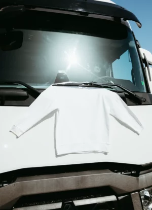 Jumper mockup hanging by a wiper blade of a truck.