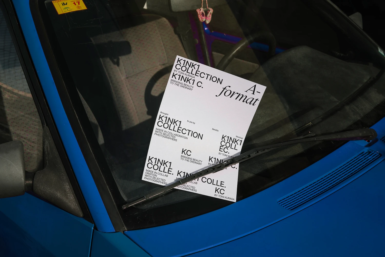 Mockup poster hanging by the wiper blade of a car.
