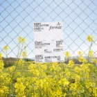 Poster mockup hanging in a fence in a flower field.