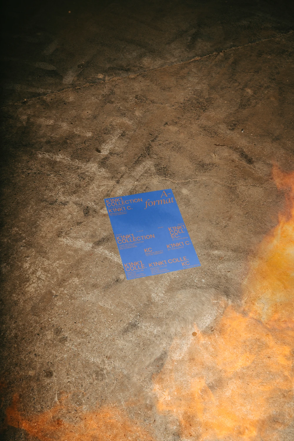 Urban poster mockup placed in the floor and surrounded by fire.