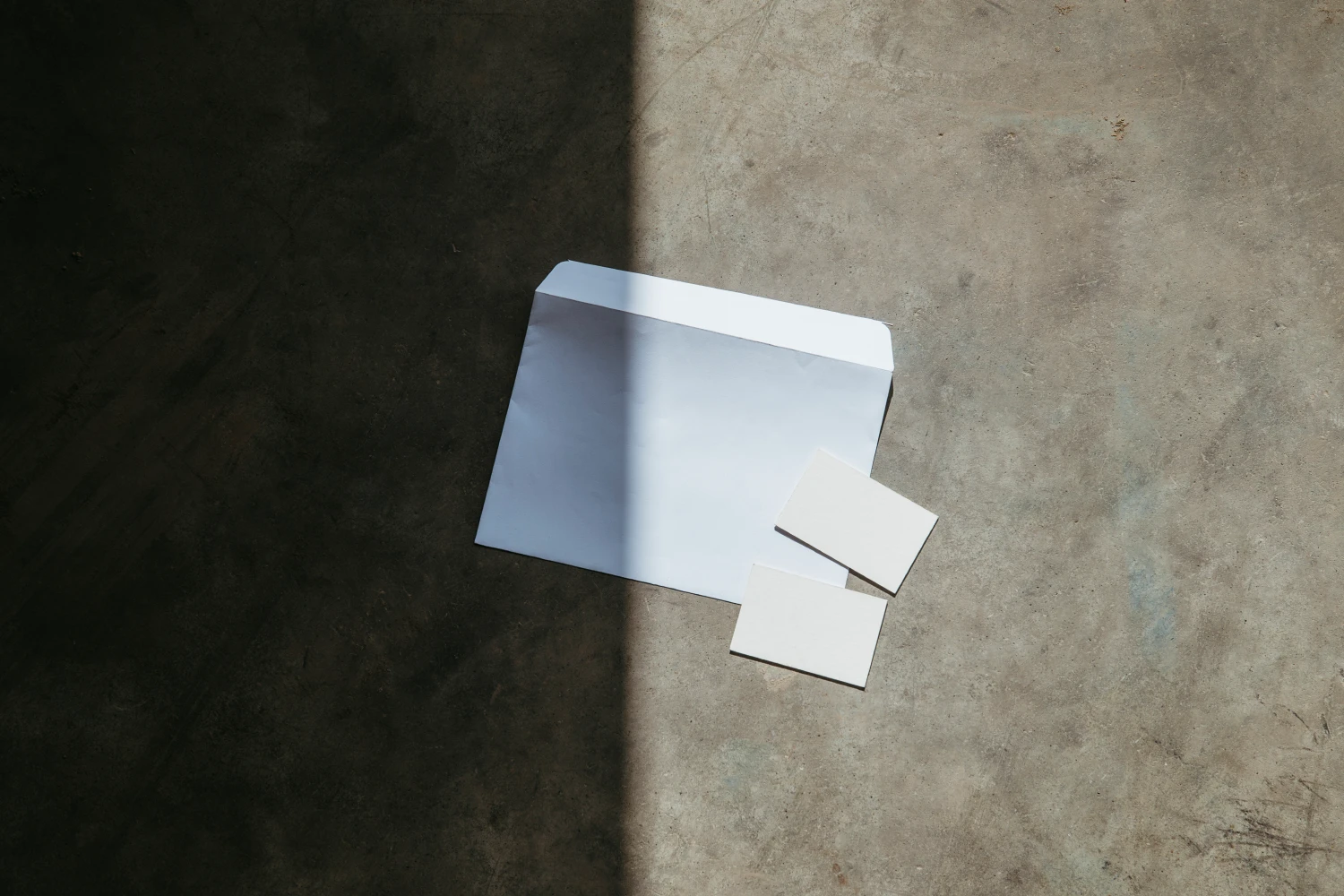 Stationery mockup placed in the groundfloor with a strong contrast between light and shadows.
