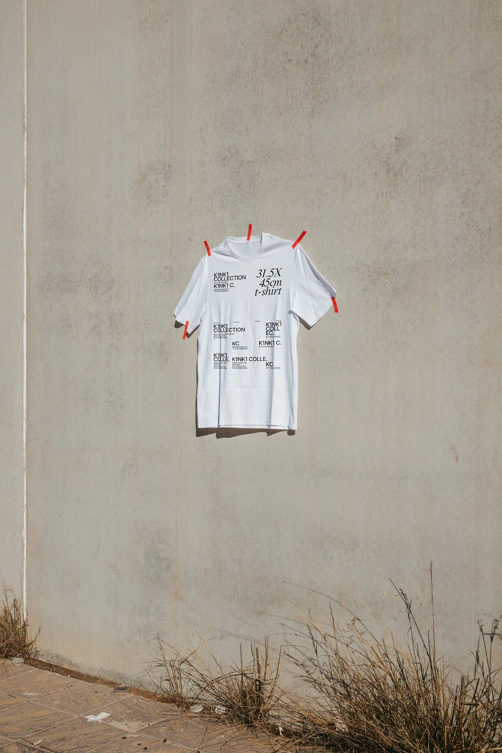 Urban t-shirt mockup hanging in the wall.