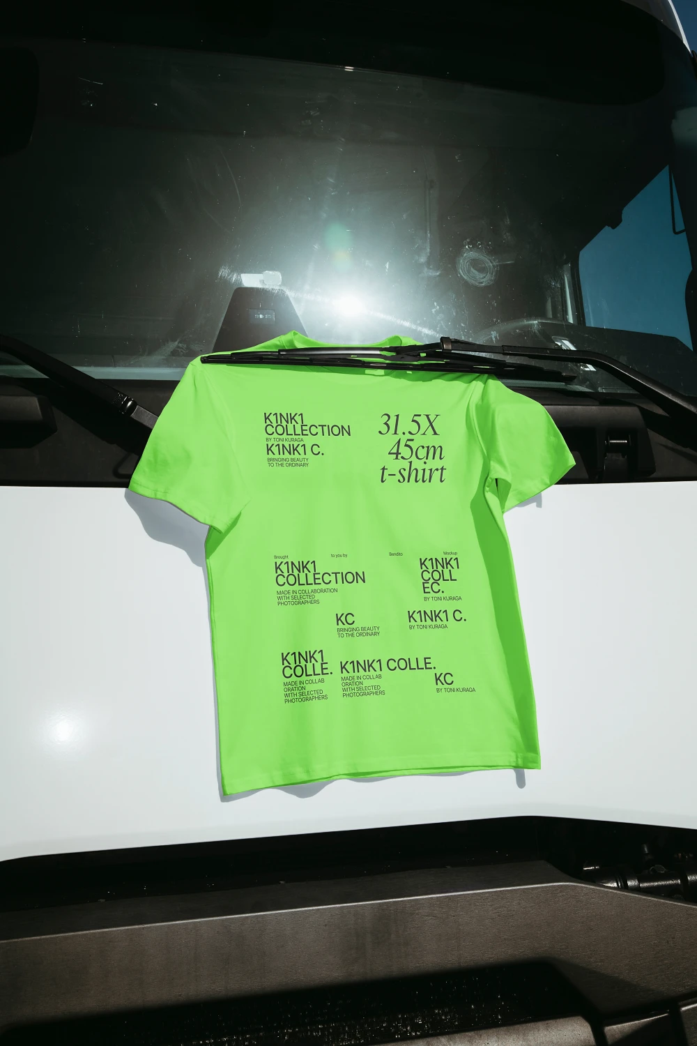 Urban t-shirt mockup hanging by the wiper blade of a truck.