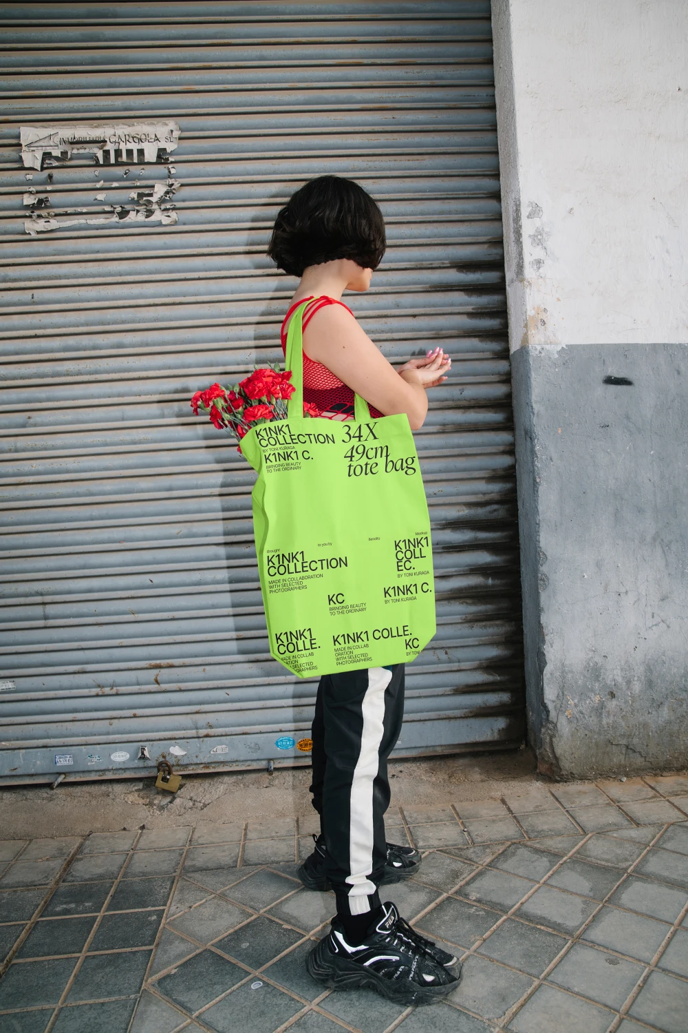 Urban tote bag mockup worn by a girl wearing streetwear.