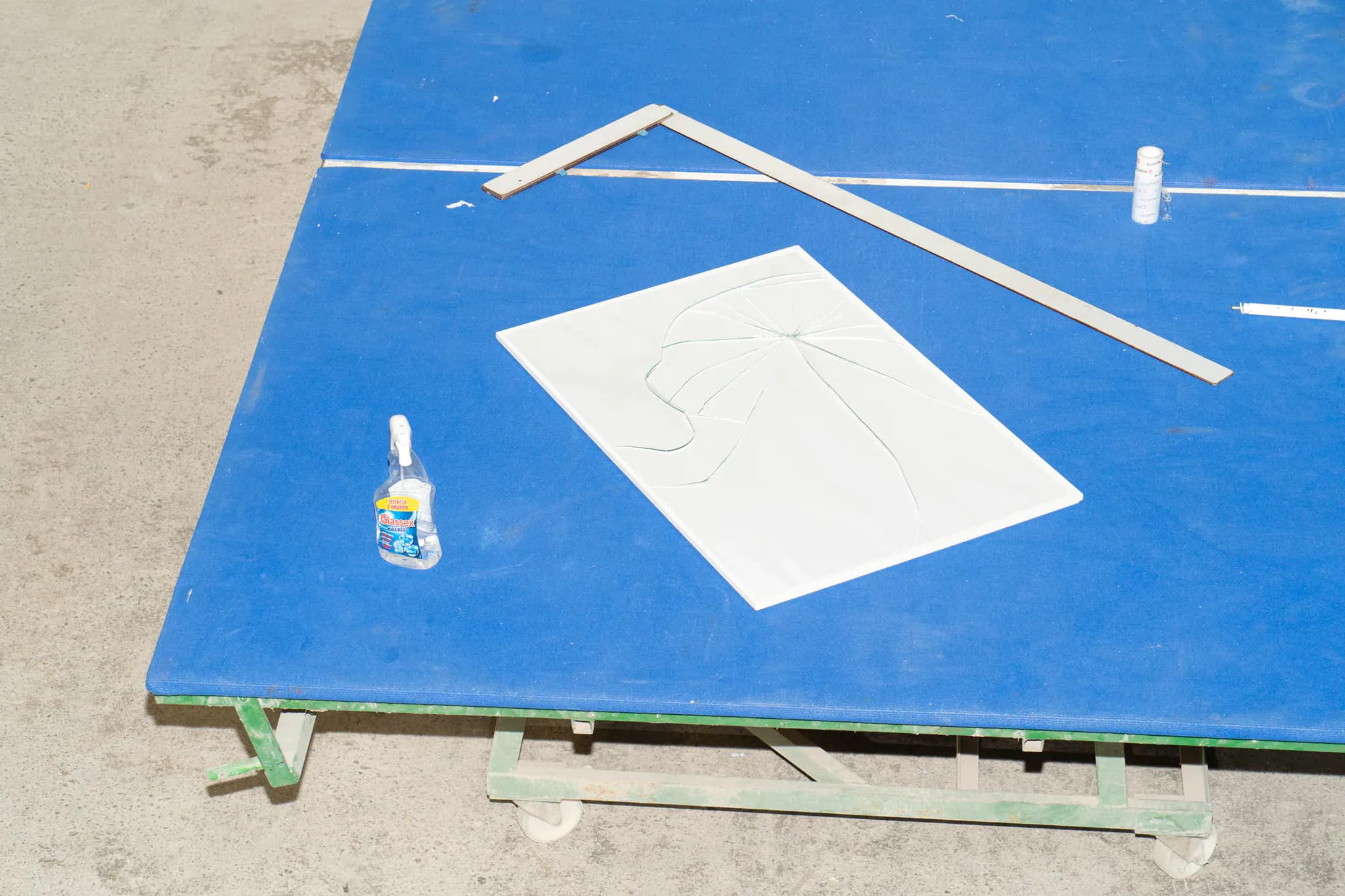 61X91cm poster broken glass framed mockup on top of a blue table