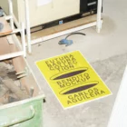 Poster mockup placed on the floor next to a bin with broken glasses inside