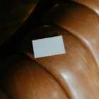 Business card mockup on top of a fancy brown leather couch
