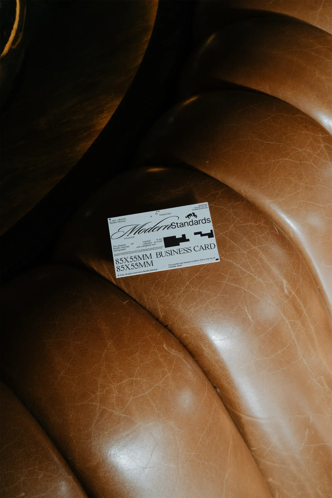 Business card mockup on top of a fancy brown leather couch