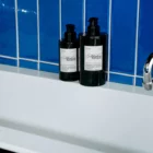 Hand soap mockup on a fancy sink in front of an elegant blue wall