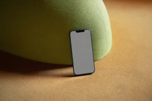 Iphone mockup on top of an orange couch