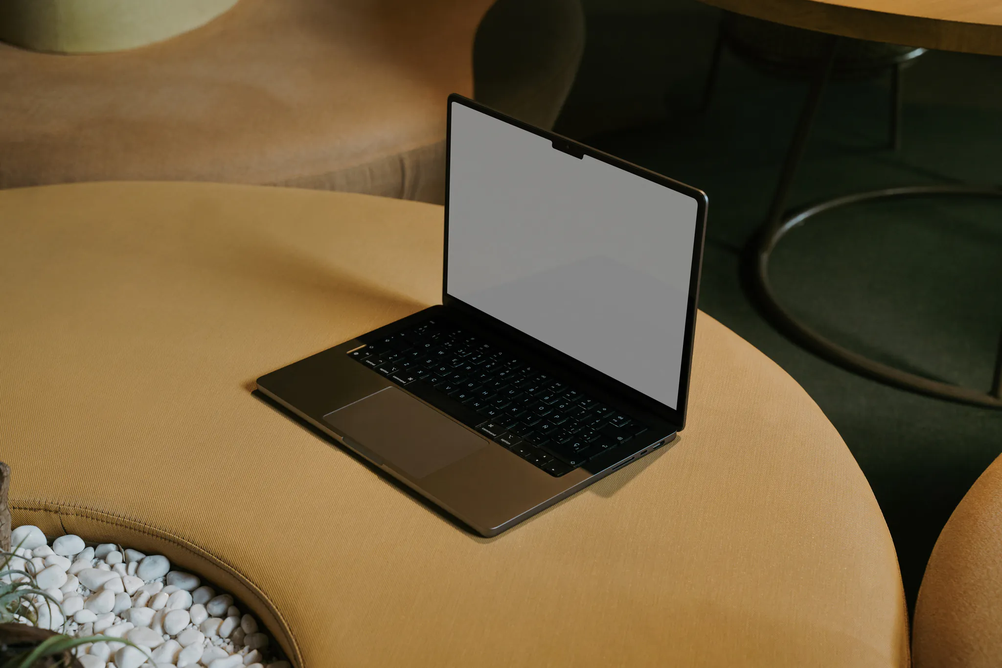 Macbook Pro mockup over a round yellow couch