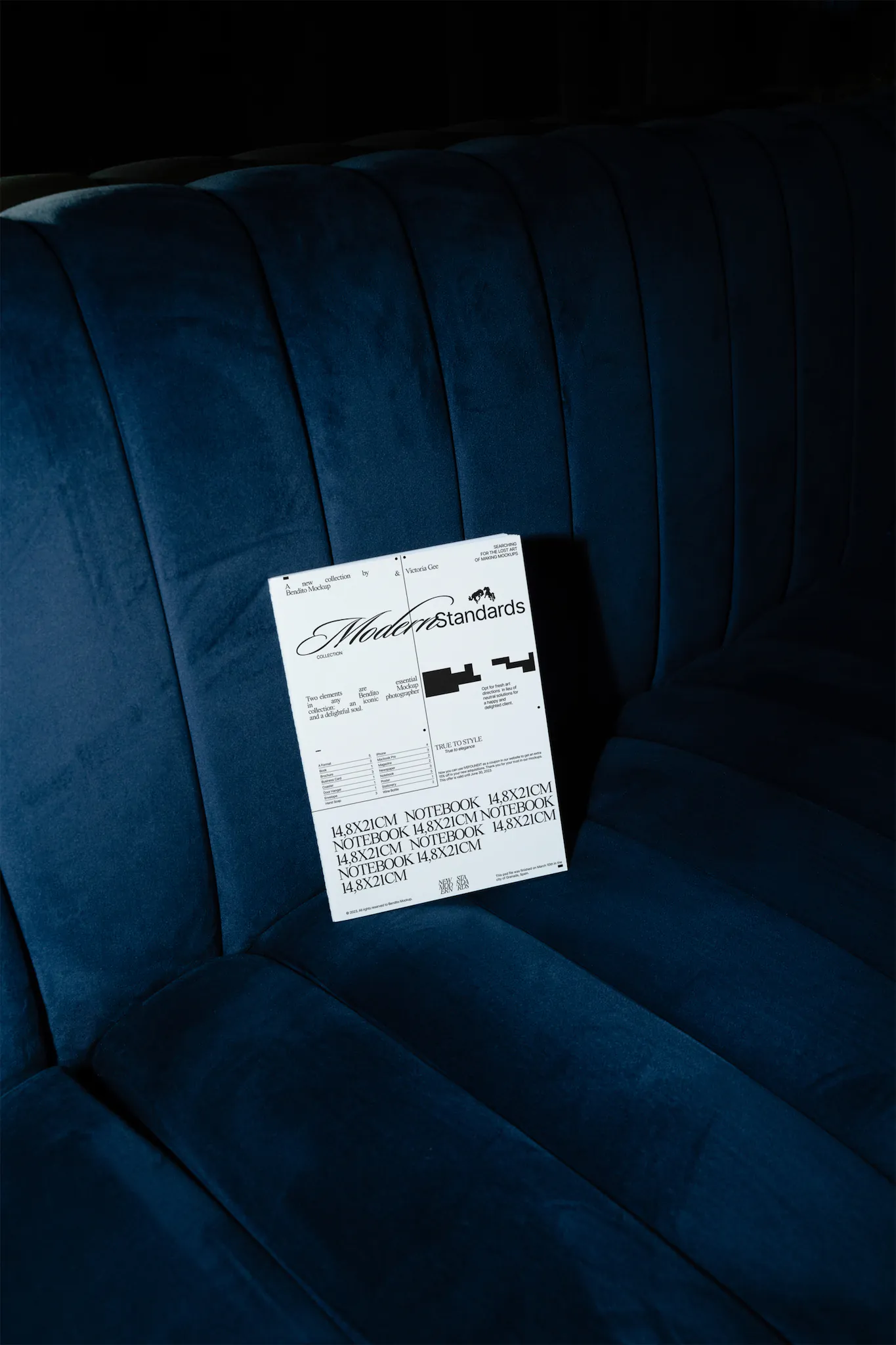 Notebook mockup on top of an elegant blue couch