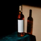 Wine bottle mockup standing on a fancy table with a green tablecloth