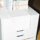 Open magazine mockup on top of a white chest of drawers