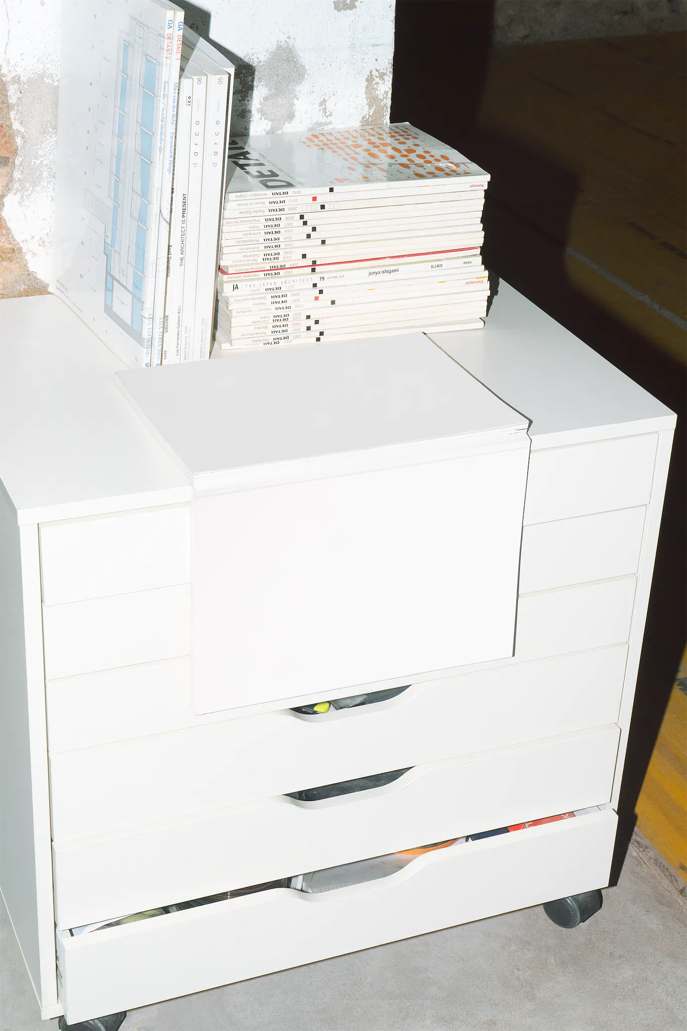 Open magazine mockup on top of a white chest of drawers