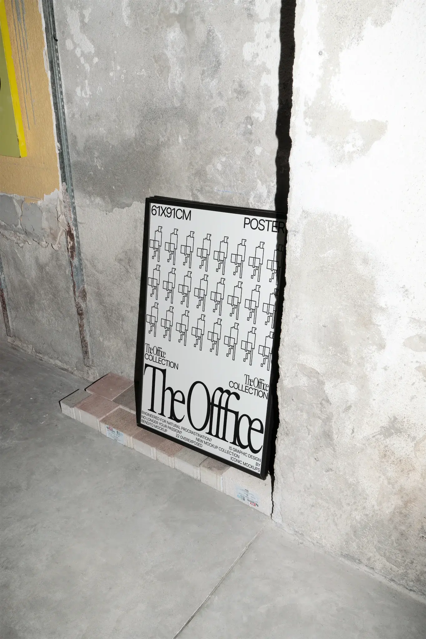 61x91cm framed poster mockup on top of bricks and leaning against a peeled wall