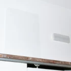 A-Format mockup on top of a sliding door gear next to a light on a white wall