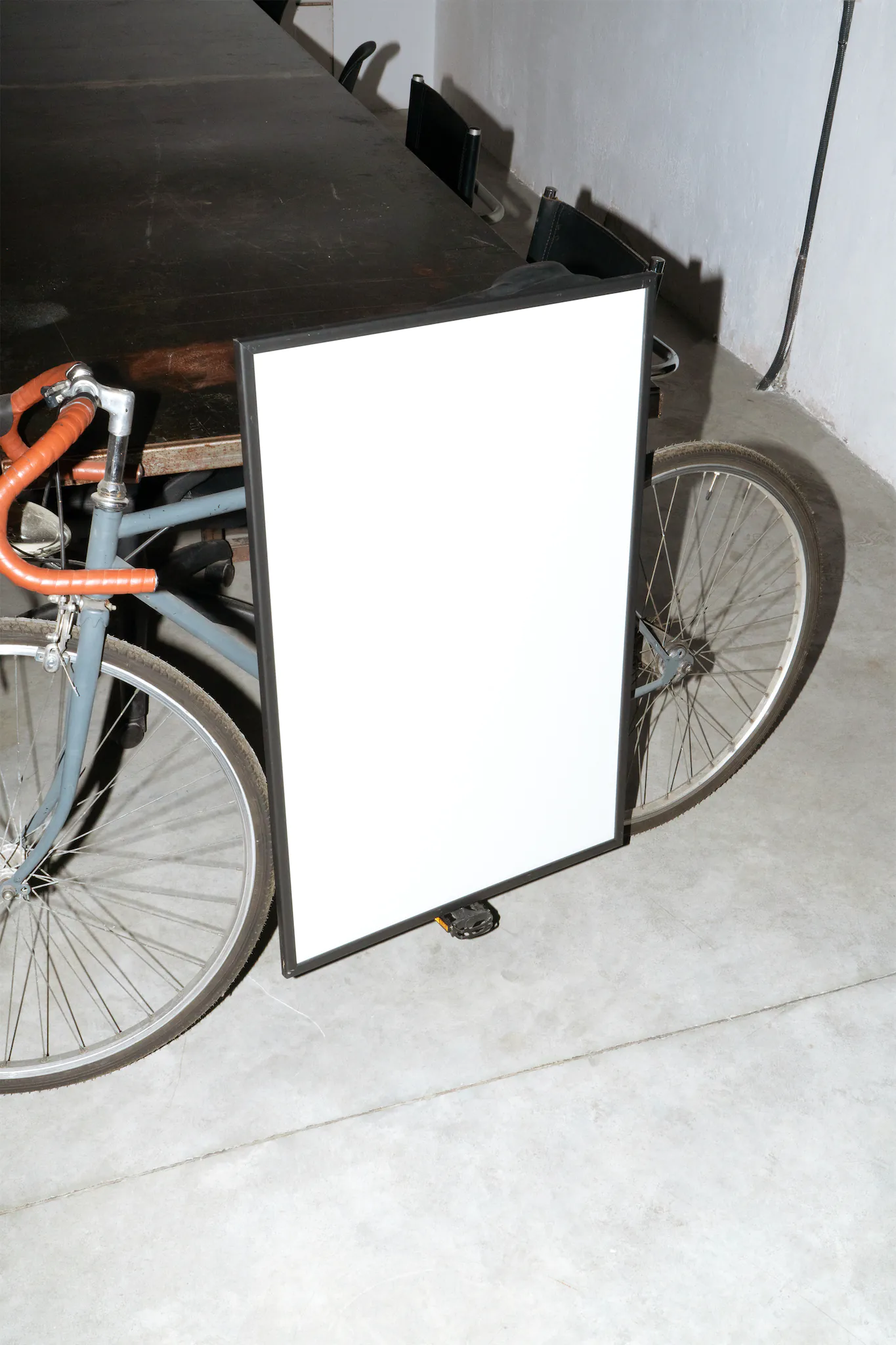 Framed poster on a pedal of a bicycle