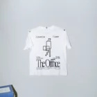 T-shirt mockup hanging on a wall with the sleeves blended next to an office table with papers on top